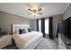 Bedroom with neutral walls, ceiling fan, carpet floors, and ensuite bathroom at 4805 W Village Se Way # 1302, Smyrna, GA 30080