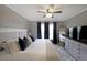 This bedroom features carpeted floors, a ceiling fan, and a large dresser with TV at 4805 W Village Se Way # 1302, Smyrna, GA 30080