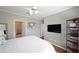 This main bedroom features hardwood floors, a ceiling fan, and a wall-mounted television at 4805 W Village Se Way # 1302, Smyrna, GA 30080