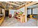 Unfinished basement area with workbench, shelving, and visible ceiling structures, ready for customization at 6828 Lockridge Dr, Atlanta, GA 30360