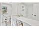 Bright bathroom with a long vanity and sink with a mirror and tile flooring at 6828 Lockridge Dr, Atlanta, GA 30360