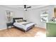 Bright bedroom features natural light, hardwood floors, ceiling fan and modern furniture at 6828 Lockridge Dr, Atlanta, GA 30360