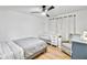 Comfortable bedroom with hardwood floors, ceiling fan, window and rocking chair with crib at 6828 Lockridge Dr, Atlanta, GA 30360