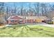 Charming brick home with a well-manicured lawn and a covered carport at 6828 Lockridge Dr, Atlanta, GA 30360