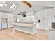 Open kitchen featuring white cabinets, a breakfast bar, and modern lighting at 6828 Lockridge Dr, Atlanta, GA 30360
