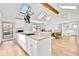 Well-lit kitchen featuring white cabinetry, an island with seating, and hardwood floors at 6828 Lockridge Dr, Atlanta, GA 30360