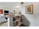 Open bar area featuring shelves stocked with various beverages and glassware adjacent to living room at 812 Bonnie Glen Se Dr, Marietta, GA 30067