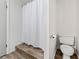 Bathroom featuring a shower with a white curtain, toilet, and wood flooring at 812 Bonnie Glen Se Dr, Marietta, GA 30067
