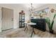 Bright dining area with hardwood floors, large window, elegant display case, and modern lighting at 812 Bonnie Glen Se Dr, Marietta, GA 30067