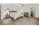 Bright main bedroom featuring wood-look flooring, ceiling fan, and stylish furnishings at 812 Bonnie Glen Se Dr, Marietta, GA 30067