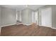 Bedroom with wood-look floors and staircase access to the kitchen at 1883 Clarke Ln, Decatur, GA 30035