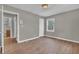 Bedroom features wood-look floors, view of the yard, and closet at 1883 Clarke Ln, Decatur, GA 30035