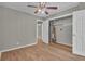 Bedroom with wood-look floors, ceiling fan, and closet with water heater, in a home for sale at 1883 Clarke Ln, Decatur, GA 30035