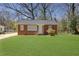 Charming brick home features a well-maintained lawn and classic architectural details at 1883 Clarke Ln, Decatur, GA 30035