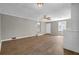 Spacious living room features wood-look floors, ceiling fan, and freshly painted walls at 1883 Clarke Ln, Decatur, GA 30035