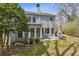 Backyard patio area with lush greenery, a stone path, and mature trees at 3923 Ashford Lake Ne Ct, Brookhaven, GA 30319