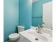 Powder room features modern fixtures, vanity, and blue painted walls at 3923 Ashford Lake Ne Ct, Brookhaven, GA 30319