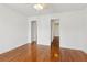 Light-filled bedroom with hardwood floors, neutral paint, and a view of other rooms at 3923 Ashford Lake Ne Ct, Brookhaven, GA 30319