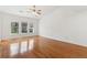 Bright bedroom featuring hardwood floors, a ceiling fan, and large windows for ample natural light at 3923 Ashford Lake Ne Ct, Brookhaven, GA 30319