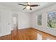 Well-lit bedroom featuring wood floors, a ceiling fan, and windows with natural light at 3923 Ashford Lake Ne Ct, Brookhaven, GA 30319