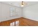 Sunlit bedroom with hardwood floors, neutral paint, and shuttered windows at 3923 Ashford Lake Ne Ct, Brookhaven, GA 30319