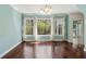 A well-lit dining area with large windows providing a view of the surrounding greenery and hardwood flooring at 3923 Ashford Lake Ne Ct, Brookhaven, GA 30319