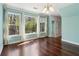 Bright dining space with ample natural light from large windows, complemented by wood floors at 3923 Ashford Lake Ne Ct, Brookhaven, GA 30319