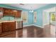 A cheerful kitchen area featuring wood cabinets, stainless steel appliances, and wood flooring for a cozy feel at 3923 Ashford Lake Ne Ct, Brookhaven, GA 30319