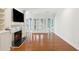 Open living room featuring fireplace, hardwood floors, and french doors at 3923 Ashford Lake Ne Ct, Brookhaven, GA 30319
