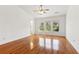 A spacious main bedroom with bright hardwood floors, many windows, and an ensuite bath at 3923 Ashford Lake Ne Ct, Brookhaven, GA 30319