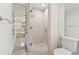 Modern bathroom featuring a glass-enclosed shower with tile surround, plus an adjacent shelf with mirrored backing at 3923 Ashford Lake Ne Ct, Brookhaven, GA 30319