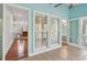 Bright sunroom with natural light showcases the doorway to the backyard and beautiful hardwood flooring at 3923 Ashford Lake Ne Ct, Brookhaven, GA 30319