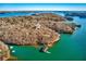 Breathtaking aerial view of a home site and private boat dock on a tranquil lake surrounded by nature at 4595 Ryker Rd, Cumming, GA 30041