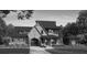 Elegant home boasts a charming facade with unique architectural details and lush landscaping, enhancing curb appeal at 4595 Ryker Rd, Cumming, GA 30041