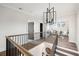 Hallway with hardwood floors, a black railing, and a modern light fixture at 4595 Ryker Rd, Cumming, GA 30041
