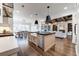 Open kitchen with stainless steel appliances, a farmhouse sink, and views of the dining and living rooms at 4595 Ryker Rd, Cumming, GA 30041