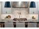 Gourmet kitchen features white cabinetry, tiled backsplash, and a large island with seating, perfect for gatherings at 4595 Ryker Rd, Cumming, GA 30041