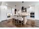 Bright kitchen features white cabinetry, stainless appliances, dark island countertop, and hardwood floors at 4595 Ryker Rd, Cumming, GA 30041