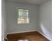 Cozy bedroom featuring hardwood floors, a window with natural light, and fresh neutral walls at 877 Verona Dr, Clarkston, GA 30021