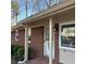 Exterior of a brick home with a front door with brick pavers, white trim, and a storm door at 877 Verona Dr, Clarkston, GA 30021