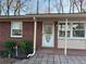 Charming single-story brick home featuring a welcoming front door and well-maintained landscaping at 877 Verona Dr, Clarkston, GA 30021
