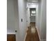 The hallway features hardwood floors and neutral paint, with several doors leading to other rooms at 877 Verona Dr, Clarkston, GA 30021