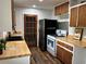 This updated kitchen features butcher block countertops, modern appliances, wood cabinets and a new refrigerator at 877 Verona Dr, Clarkston, GA 30021