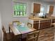 Bright eat-in kitchen features wood cabinets and countertops and views of the outdoors at 877 Verona Dr, Clarkston, GA 30021