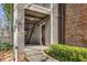 Apartment building entrance featuring brick and siding, with stairway to upper level unit at 102 Barrington Hills Dr, Atlanta, GA 30350