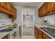 Classic kitchen with wood cabinets, white appliances, and tile flooring at 102 Barrington Hills Dr, Atlanta, GA 30350