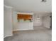 Open concept condo with gray carpet, white walls, and view to dining area and kitchen at 102 Barrington Hills Dr, Atlanta, GA 30350