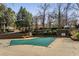 Community pool covered for the off-season, surrounded by trees and landscaping at 102 Barrington Hills Dr, Atlanta, GA 30350