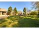 Spacious backyard with a swimming pool and mature trees, offering a peaceful and private outdoor space at 2272 Kimberley Way, Snellville, GA 30078