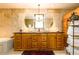 The ensuite bathroom features travertine-tiled walls, double sinks, and a black countertop at 2272 Kimberley Way, Snellville, GA 30078